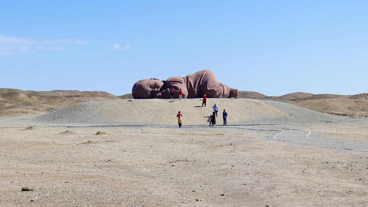 Sculpture of a giant reclining baby, near Guazhou