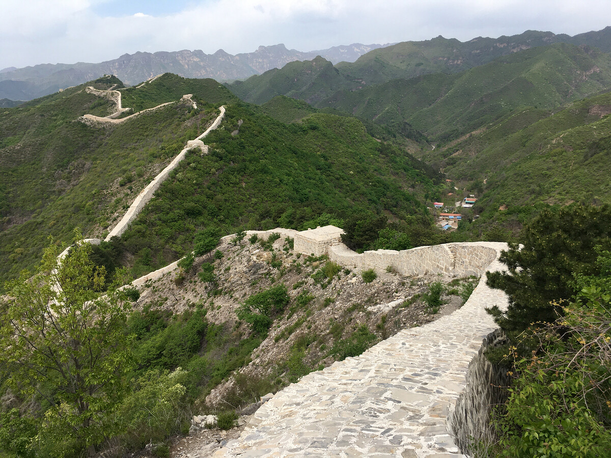 Repaired Great Wall, green hills.