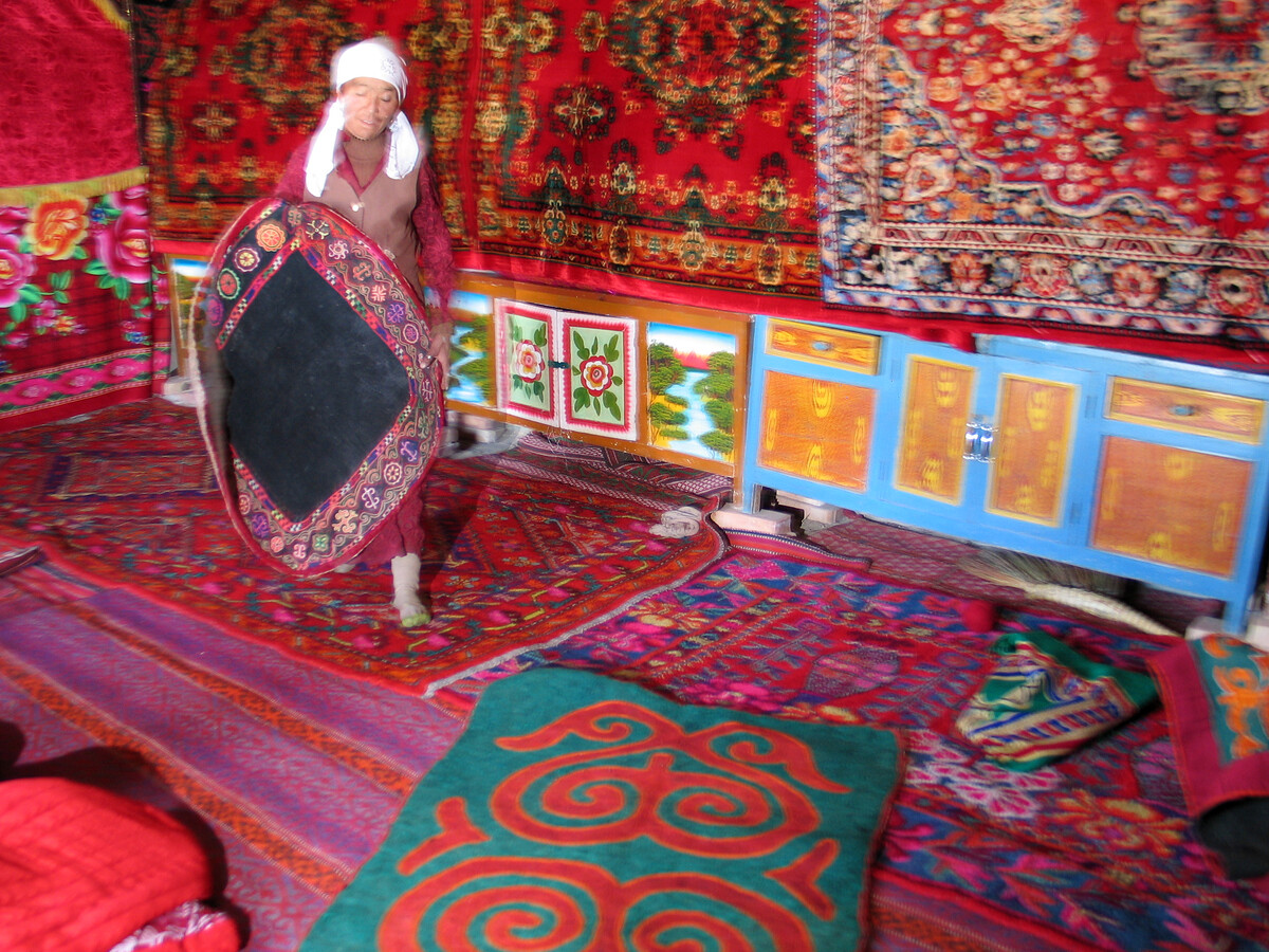 Carpets cover the floor and wall in a village house
