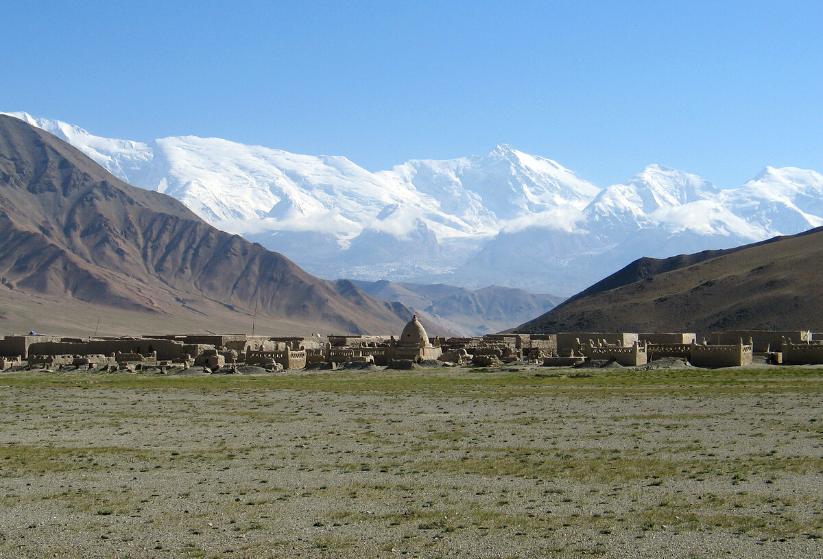 A cemetery with snowy mountains behind