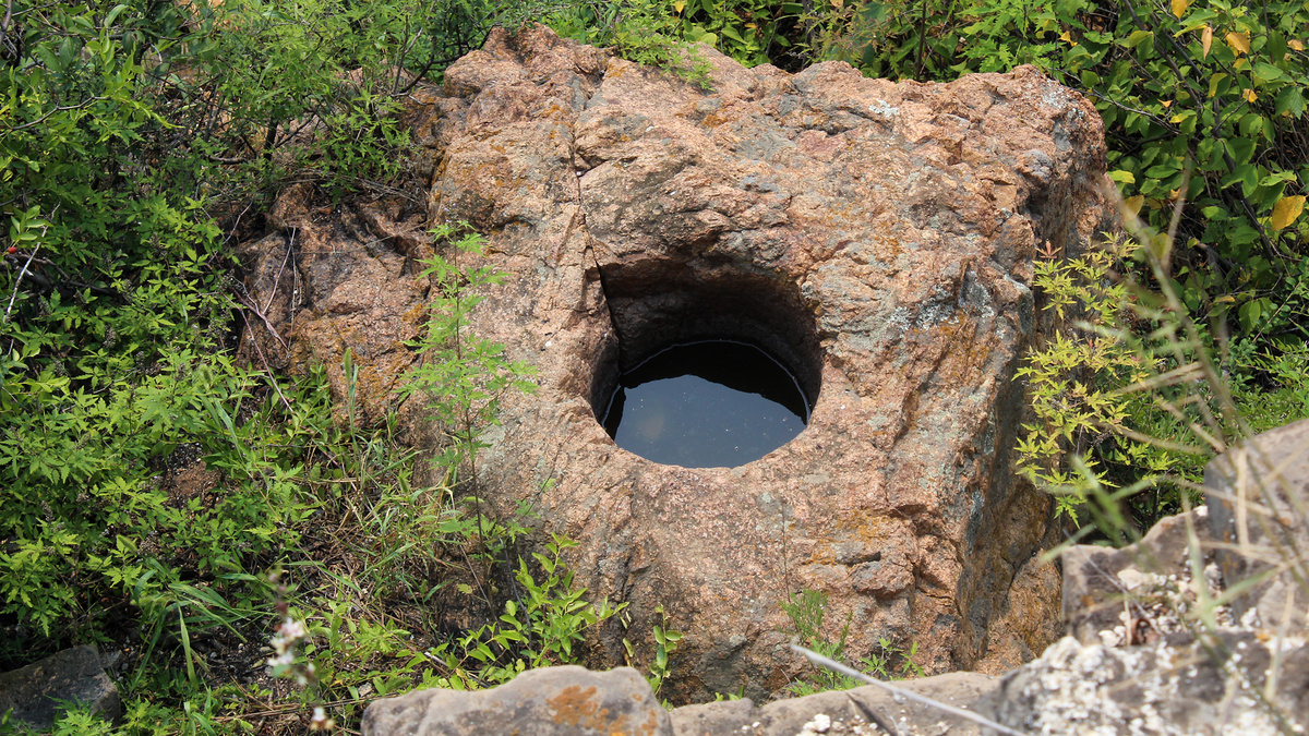 A circular bore in a rock near the Great Wall at Gubeikou.
