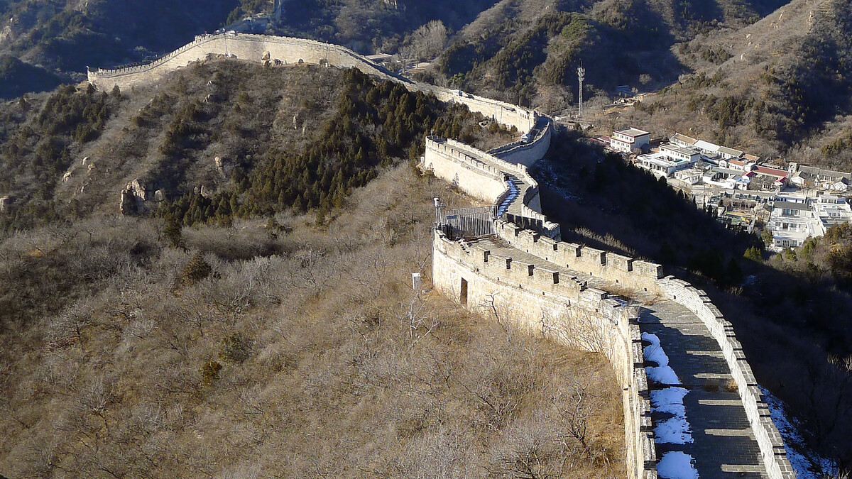 Great Wall on a ridge, with a village below.