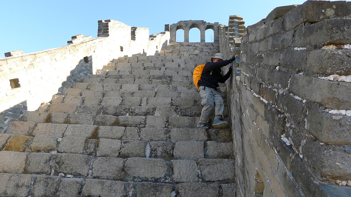A hiker on a steep section of Great Wall