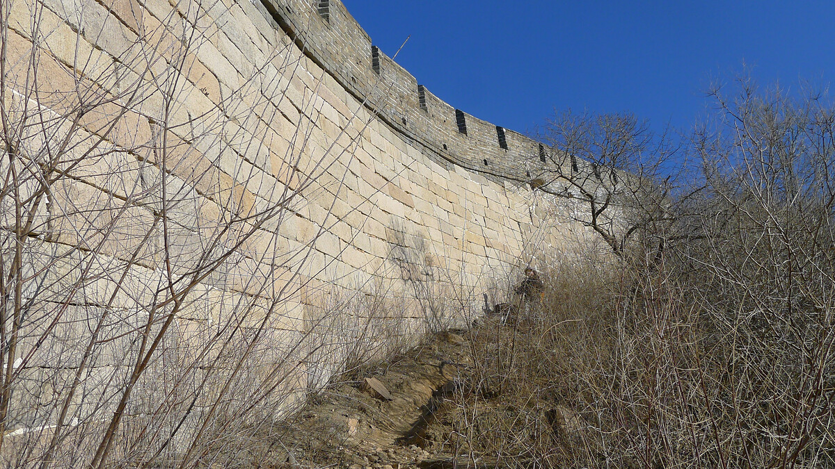 On a track by the foundation of the wall