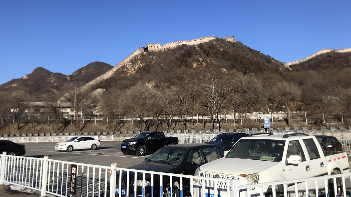 Great Wall on a ridge above a car park.